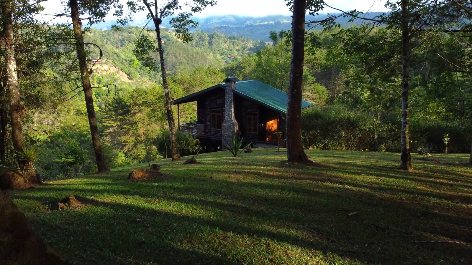 Cabins in the forest at Verdesana in evening light