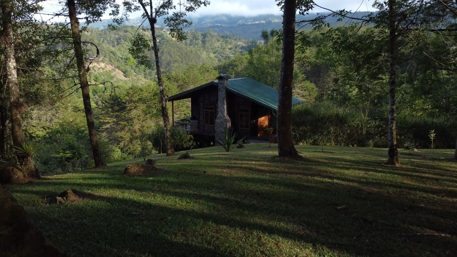 Cabins in the forest at Verdesana in evening light