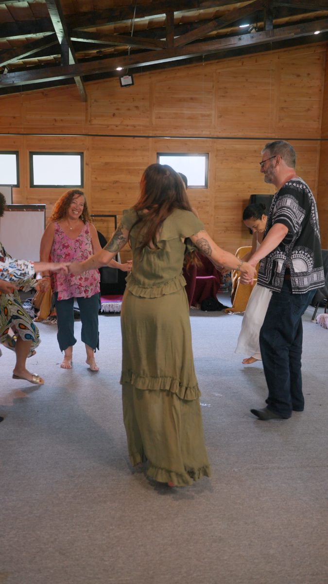 A circle of guests holding hands in ceremony